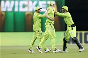 CANBERRA, AUSTRALIA - DECEMBER 22: Usman Khawaja of the Thunder celebrates with team mates after taking a catch to dismiss Jason Roy of the Scorches during the Big Bash League match between the Sydney Thunder and the Perth Scorchers at Manuka Oval, on December 22, 2020, in Canberra, Australia. (Photo by Darrian Traynor/Getty Images)