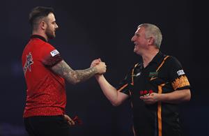 LONDON, ENGLAND - DECEMBER 22: Joe Cullen of England (L) and Wayne Jones of England congratulate each other after there second round match against during day eight of the PDC William Hill World Darts Championship at Alexandra Palace on December 22, 2020 in London, England. (Photo by Luke Walker/Getty Images)