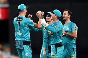 BRISBANE, AUSTRALIA - DECEMBER 27: James Bazley of the Heat celebrates after taking the catch to dismiss Darcy Short of the Hurricanes during the Big Bash League match between the Brisbane Heat and the Hobart Hurricanes at The Gabba, on December 27, 2020, in Brisbane, Australia. (Photo by Bradley Kanaris/Getty Images)