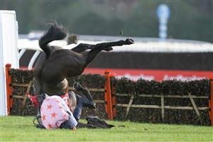 SUNBURY, ENGLAND - DECEMBER 27: Chester Williams riding Honneur d'Ajonc fall at the last with the race at their mercy in The Get Your Ladbrokes 1 Free Bet Introductory Juvenile Hurdle at Kempton Park Racecourse on December 27, 2020 in Sunbury, England. Owners are allowed to attend if they have a runner at the meeting otherwise racing remains behind closed doors to the public due to the Coronavirus pandemic. (Photo by Alan Crowhurst/Getty Images)