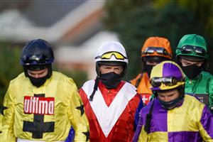 SUNBURY, ENGLAND - DECEMBER 27: Jockey David Crosse (white cap) makes his way to the parade ring on his last day as a professional jockey at Kempton Park Racecourse on December 27, 2020 in Sunbury, England. Owners are allowed to attend if they have a runner at the meeting otherwise racing remains behind closed doors to the public due to the Coronavirus pandemic. (Photo by Alan Crowhurst/Getty Images)