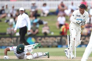 TAURANGA, NEW ZEALAND - DECEMBER 28: Fawad Alam of Pakistan dives to make his ground as BJ Watling of New Zealand attempts a runout during day three of the First Test match in the series between New Zealand and Pakistan at Bay Oval on December 28, 2020 in Tauranga, New Zealand. (Photo by Phil Walter/Getty Images)
