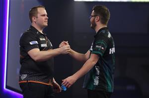 LONDON, ENGLAND - DECEMBER 28: Dirk van Duijvenbode of The Netherlands (L)and Adam Hunt of England congratulate each other after there third round match against during day eleven of the PDC William Hill World Darts Championship at Alexandra Palace on December 28, 2020 in London, England. (Photo by Luke Walker/Getty Images)