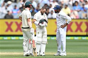 MELBOURNE, AUSTRALIA - DECEMBER 28: Matthew Wade of Australia inspects his helmet after being struck on the helmet by a delivery from Jasprit Bumrah of India during day three of the Second Test match between Australia and India at Melbourne Cricket Ground on December 28, 2020 in Melbourne, Australia. (Photo by Quinn Rooney/Getty Images)