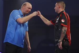 LONDON, ENGLAND - DECEMBER 28: Vincent van der Voort of The Netherlands (L) and Nathan Aspinall of England congratulate each other after there third round match against during day eleven of the PDC William Hill World Darts Championship at Alexandra Palace on December 28, 2020 in London, England. (Photo by Luke Walker/Getty Images)