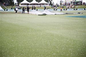 TAURANGA, NEW ZEALAND - DECEMBER 28: The covers are brought on as hail falls onto the ground during day three of the First Test match in the series between New Zealand and Pakistan at Bay Oval on December 28, 2020 in Tauranga, New Zealand. (Photo by Phil Walter/Getty Images)