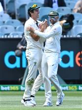 MELBOURNE, AUSTRALIA - DECEMBER 28: Pat Cummins of Australia is congratulated by Nathan Lyon after taking a catch to dismiss Ravindra Jadeja of India during day three of the Second Test match between Australia and India at Melbourne Cricket Ground on December 28, 2020 in Melbourne, Australia. (Photo by Quinn Rooney/Getty Images)