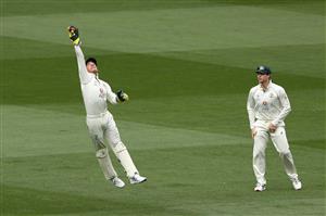 MELBOURNE, AUSTRALIA - DECEMBER 28: Tim Paine of Australia leaps for the ball as Steve Smith looks on on during day three of the Second Test match between Australia and India at Melbourne Cricket Ground on December 28, 2020 in Melbourne, Australia. (Photo by Robert Cianflone/Getty Images)
