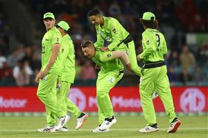 CANBERRA, AUSTRALIA - DECEMBER 29: Tanveer Sangha of the Thunder jumps on the back of Daniel Sams of the Thunder after dismissing Nicholas Pooran of the Stars during the Big Bash League match between Sydney Thunder and the Melbourne Stars at Manuka Oval, on December 29, 2020, in Canberra, Australia. (Photo by Mike Owen/Getty Images)