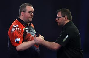 LONDON, ENGLAND - DECEMBER 29: Stephen Bunting of England (L) and James Wade of England congratulate each other after there third round match against during day twelve of the PDC William Hill World Darts Championship at Alexandra Palace on December 29, 2020 in London, England. (Photo by Luke Walker/Getty Images)