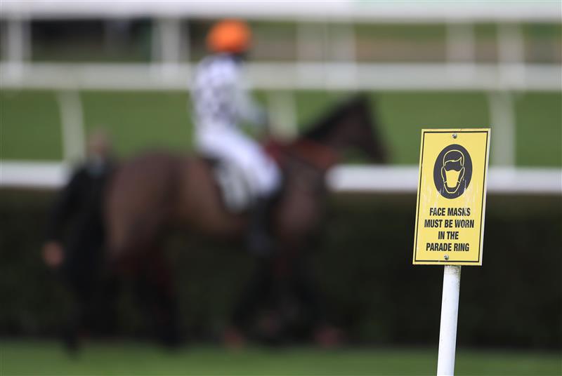 MARKET RASEN, ENGLAND - DECEMBER 30: Face mask signage is seen at Market Rasen Racecourse on December 30, 2020 in Market Rasen, England. (Photo by Mike Egerton - Pool/Getty Images)