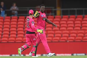 GOLD COAST, AUSTRALIA - DECEMBER 29: Carlos Brathwaite of the Sixers celebrates dismissing Shaun Marsh of the Renegades during the Big Bash League match between the Melbourne Renegades and the Sydney Sixers at Metricon Stadium, on December 29, 2020, in Gold Coast, Australia. (Photo by Chris Hyde/Getty Images)