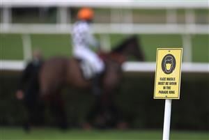 MARKET RASEN, ENGLAND - DECEMBER 30: Face mask signage is seen at Market Rasen Racecourse on December 30, 2020 in Market Rasen, England. (Photo by Mike Egerton - Pool/Getty Images)