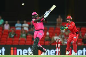 GOLD COAST, AUSTRALIA - DECEMBER 29: Jason Holder of the Sixers bats during the Big Bash League match between the Melbourne Renegades and the Sydney Sixers at Metricon Stadium, on December 29, 2020, in Gold Coast, Australia. (Photo by Chris Hyde/Getty Images)