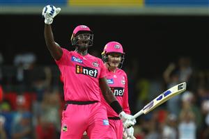 GOLD COAST, AUSTRALIA - DECEMBER 29: Jason Holder and Ben Manenti of the Sixers celebrate winning the Big Bash League match between the Melbourne Renegades and the Sydney Sixers at Metricon Stadium, on December 29, 2020, in Gold Coast, Australia. (Photo by Chris Hyde/Getty Images)