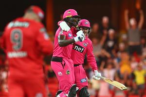 GOLD COAST, AUSTRALIA - DECEMBER 29: Jason Holder and Ben Manenti of the Sixers celebrate winning the Big Bash League match between the Melbourne Renegades and the Sydney Sixers at Metricon Stadium, on December 29, 2020, in Gold Coast, Australia. (Photo by Chris Hyde/Getty Images)