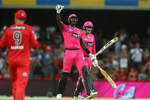 GOLD COAST, AUSTRALIA - DECEMBER 29: Jason Holder and Ben Manenti of the Sixers celebrate winning the Big Bash League match between the Melbourne Renegades and the Sydney Sixers at Metricon Stadium, on December 29, 2020, in Gold Coast, Australia. (Photo by Chris Hyde/Getty Images)