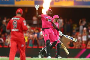 GOLD COAST, AUSTRALIA - DECEMBER 29: Jason Holder and Ben Manenti of the Sixers celebrate winning the Big Bash League match between the Melbourne Renegades and the Sydney Sixers at Metricon Stadium, on December 29, 2020, in Gold Coast, Australia. (Photo by Chris Hyde/Getty Images)