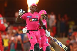 GOLD COAST, AUSTRALIA - DECEMBER 29: Jason Holder and Ben Manenti of the Sixers celebrate winning the Big Bash League match between the Melbourne Renegades and the Sydney Sixers at Metricon Stadium, on December 29, 2020, in Gold Coast, Australia. (Photo by Chris Hyde/Getty Images)
