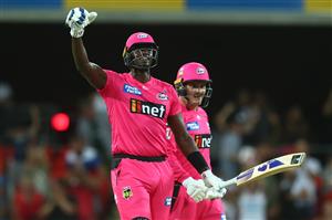 GOLD COAST, AUSTRALIA - DECEMBER 29: Jason Holder and Ben Manenti of the Sixers celebrate winning the Big Bash League match between the Melbourne Renegades and the Sydney Sixers at Metricon Stadium, on December 29, 2020, in Gold Coast, Australia. (Photo by Chris Hyde/Getty Images)