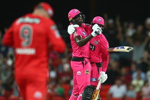 GOLD COAST, AUSTRALIA - DECEMBER 29: Jason Holder and Ben Manenti of the Sixers celebrate winning the Big Bash League match between the Melbourne Renegades and the Sydney Sixers at Metricon Stadium, on December 29, 2020, in Gold Coast, Australia. (Photo by Chris Hyde/Getty Images)