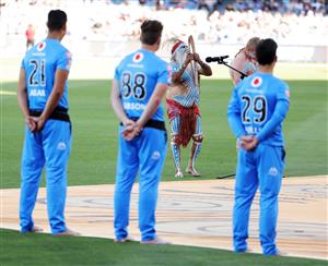 ADELAIDE, AUSTRALIA - DECEMBER 31: Players and officials are pictured during a barefoot ceremony and welcome to country prior to play during the Big Bash League match between the Strikers and Scorchers at Adelaide Oval, on December 31, 2020, in Adelaide, Australia. (Photo by Daniel Kalisz/Getty Images)