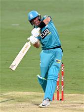 BRISBANE, AUSTRALIA - DECEMBER 30: James Bazley of the Heat hits the ball to the boundary for a four during the Big Bash League match between the Hobart Hurricanes and Brisbane Heat at The Gabba, on December 30, 2020, in Brisbane, Australia. (Photo by Bradley Kanaris/Getty Images)