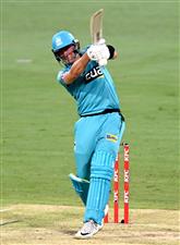 BRISBANE, AUSTRALIA - DECEMBER 30: James Bazley of the Heat hits the ball to the boundary for a four during the Big Bash League match between the Hobart Hurricanes and Brisbane Heat at The Gabba, on December 30, 2020, in Brisbane, Australia. (Photo by Bradley Kanaris/Getty Images)