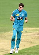BRISBANE, AUSTRALIA - DECEMBER 30: Xavier Bartlett of the Heat celebrates taking the wicket of Tim David of the Hurricanes during the Big Bash League match between the Hobart Hurricanes and Brisbane Heat at The Gabba, on December 30, 2020, in Brisbane, Australia. (Photo by Bradley Kanaris/Getty Images)