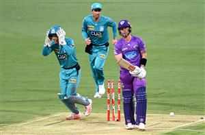 BRISBANE, AUSTRALIA - DECEMBER 30: Ben McDermott of the Hurricanes is bowled out by Mujeeb Ur Rahman of the Heat during the Big Bash League match between the Hobart Hurricanes and Brisbane Heat at The Gabba, on December 30, 2020, in Brisbane, Australia. (Photo by Bradley Kanaris/Getty Images)