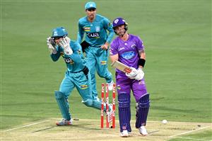 BRISBANE, AUSTRALIA - DECEMBER 30: Ben McDermott of the Hurricanes is bowled out by Mujeeb Ur Rahman of the Heat during the Big Bash League match between the Hobart Hurricanes and Brisbane Heat at The Gabba, on December 30, 2020, in Brisbane, Australia. (Photo by Bradley Kanaris/Getty Images)