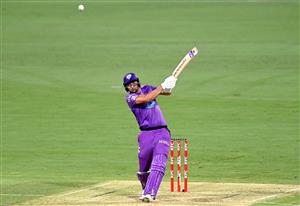 BRISBANE, AUSTRALIA - DECEMBER 30: Tim David of the Hurricanes hits the ball to the boundary for a four during the Big Bash League match between the Hobart Hurricanes and Brisbane Heat at The Gabba, on December 30, 2020, in Brisbane, Australia. (Photo by Bradley Kanaris/Getty Images)