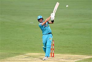 BRISBANE, AUSTRALIA - DECEMBER 30: James Bazley of the Heat hits the ball to the boundary for a four during the Big Bash League match between the Hobart Hurricanes and Brisbane Heat at The Gabba, on December 30, 2020, in Brisbane, Australia. (Photo by Bradley Kanaris/Getty Images)