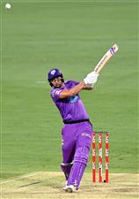 BRISBANE, AUSTRALIA - DECEMBER 30: Tim David of the Hurricanes hits the ball to the boundary for a four during the Big Bash League match between the Hobart Hurricanes and Brisbane Heat at The Gabba, on December 30, 2020, in Brisbane, Australia. (Photo by Bradley Kanaris/Getty Images)