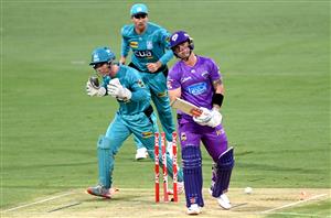 BRISBANE, AUSTRALIA - DECEMBER 30: Ben McDermott of the Hurricanes is bowled out by Mujeeb Ur Rahman of the Heat during the Big Bash League match between the Hobart Hurricanes and Brisbane Heat at The Gabba, on December 30, 2020, in Brisbane, Australia. (Photo by Bradley Kanaris/Getty Images)