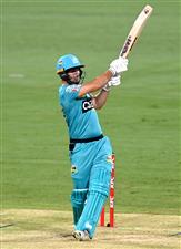 BRISBANE, AUSTRALIA - DECEMBER 30: Lewis Gregory of the Heat hits the ball to the boundary for a four during the Big Bash League match between the Hobart Hurricanes and Brisbane Heat at The Gabba, on December 30, 2020, in Brisbane, Australia. (Photo by Bradley Kanaris/Getty Images)