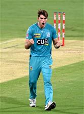 BRISBANE, AUSTRALIA - DECEMBER 30: Xavier Bartlett of the Heat celebrates taking the wicket of Tim David of the Hurricanes during the Big Bash League match between the Hobart Hurricanes and Brisbane Heat at The Gabba, on December 30, 2020, in Brisbane, Australia. (Photo by Bradley Kanaris/Getty Images)