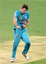BRISBANE, AUSTRALIA - DECEMBER 30: Xavier Bartlett of the Heat celebrates taking the wicket of Tim David of the Hurricanes during the Big Bash League match between the Hobart Hurricanes and Brisbane Heat at The Gabba, on December 30, 2020, in Brisbane, Australia. (Photo by Bradley Kanaris/Getty Images)