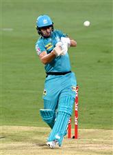 BRISBANE, AUSTRALIA - DECEMBER 30: Lewis Gregory of the Heat hits the ball to the boundary for a four during the Big Bash League match between the Hobart Hurricanes and Brisbane Heat at The Gabba, on December 30, 2020, in Brisbane, Australia. (Photo by Bradley Kanaris/Getty Images)