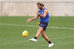 MELBOURNE, AUSTRALIA - JANUARY 06: Caleb Daniel of the Bulldogs kicks the ball during a Western Bulldogs AFL training session at Whitten Oval on January 06, 2021 in Melbourne, Australia. (Photo by Mike Owen/Getty Images)