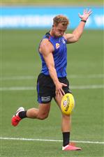 MELBOURNE, AUSTRALIA - JANUARY 06: Mitch Wallis of the Bulldogs kicks the ball during a Western Bulldogs AFL training session at Whitten Oval on January 06, 2021 in Melbourne, Australia. (Photo by Mike Owen/Getty Images)