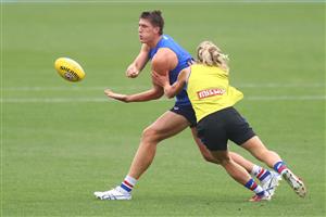 MELBOURNE, AUSTRALIA - JANUARY 06: Jordon Sweet of the Bulldogs is tackled by Cody Weightman during a Western Bulldogs AFL training session at Whitten Oval on January 06, 2021 in Melbourne, Australia. (Photo by Mike Owen/Getty Images)