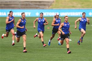 MELBOURNE, AUSTRALIA - JANUARY 06: Mitch Wallis (2l) of the Bulldogs runs during a Western Bulldogs AFL training session at Whitten Oval on January 06, 2021 in Melbourne, Australia. (Photo by Mike Owen/Getty Images)