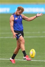 MELBOURNE, AUSTRALIA - JANUARY 06: Mitch Wallis of the Bulldogs kicks the ball during a Western Bulldogs AFL training session at Whitten Oval on January 06, 2021 in Melbourne, Australia. (Photo by Mike Owen/Getty Images)