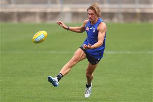 MELBOURNE, AUSTRALIA - JANUARY 06: Roarke Smith of the Bulldogs kicks the ball during a Western Bulldogs AFL training session at Whitten Oval on January 06, 2021 in Melbourne, Australia. (Photo by Mike Owen/Getty Images)