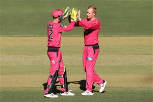 PERTH, AUSTRALIA - JANUARY 06: Josh Philippe and Lloyd Pope of the Sixers celebrate the wicket of Colin Munro of the Scorchers of the Scorchers during the Big Bash League match between the Perth Scorchers and the Sydney Sixers at Optus Stadium, on January 06, 2021, in Perth, Australia. (Photo by Paul Kane/Getty Images)