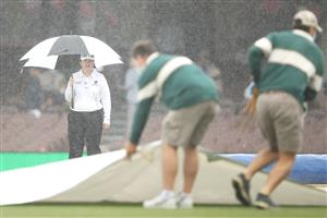 SYDNEY, AUSTRALIA - JANUARY 07: Reserve umpire Claire Polosak watches on as ground staff cover the pitch during a rain delay on day one of the Third Test match in the series between Australia and India at Sydney Cricket Ground on January 07, 2021 in Sydney, Australia. (Photo by Mark Kolbe/Getty Images)