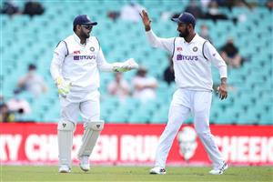 SYDNEY, AUSTRALIA - JANUARY 07: Rishabh Pant and Cheteshwar Pujara of India celebrate the wicket of Will Pucovski of Australia who was given out caught behind only to have the decision overturned after a DRS challenge during day one of the Third Test match in the series between Australia and India at Sydney Cricket Ground on January 07, 2021 in Sydney, Australia. (Photo by Mark Kolbe/Getty Images)