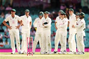 SYDNEY, AUSTRALIA - JANUARY 08: Australian players wait for a DRS review during day two of the Third Test match in the series between Australia and India at Sydney Cricket Ground on January 08, 2021 in Sydney, Australia. (Photo by Cameron Spencer/Getty Images)