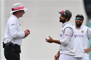 Indian captain Ajinkya Rahane (R) talks to umpire Paul Reiffel on day two of the third cricket Test match at Sydney Cricket Ground (SCG) between Australia and India in Sydney on January 8,2021. (Photo by Saeed KHAN / AFP) (Photo by SAEED KHAN/AFP via Getty Images)